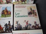 four books on a table with pictures of soldiers on them
