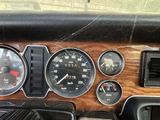 a close up of a dashboard of a car with gauges