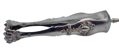 a silver spoon with a handle that has flowers on it