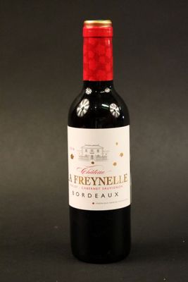 a bottle of red wine sitting on top of a black table
