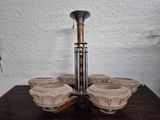 a wooden table with four vases on top of it