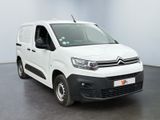 the white van is parked in a room with a black floor