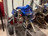 a picture of a small airless paint sprayer in a garage