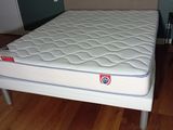 a bed with a mattress on it in a room
