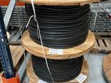 a stack of wooden pallets with black wires on them
