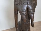 an old wooden statue of a man with a hat on his head