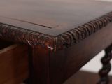a wooden table with a drawer underneath it