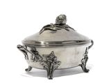 a silver plate with a bird on top of it