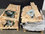 two wooden pallets with tools on them on the floor