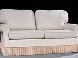 a white couch with a striped skirt on it