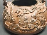 a vase with a design on it sitting on a table