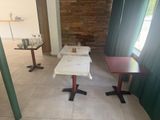 two tables that are sitting in the middle of a room