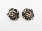 a pair of black and white diamond earrings