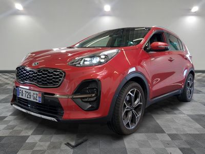 la voiture rouge est garée sur un sol en damier dans le garage