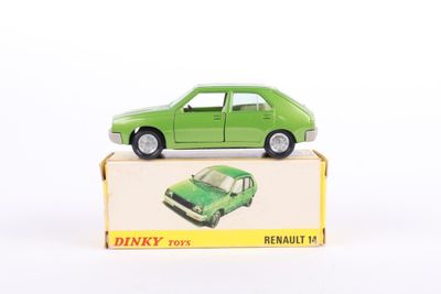 a green toy car sitting on top of a box