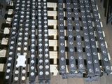 a pile of batteries on a wooden pallet on the floor