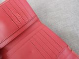 a red wallet that is open on the floor