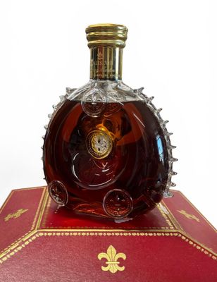 a bottle of liquor sitting on top of a red box