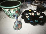 a vase and a bowl on a table next to each other
