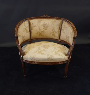 a chair with a floral upholstered back and a wooden frame