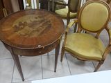 two chairs and a table with a painting on it