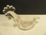 a glass bird that is sitting on a table