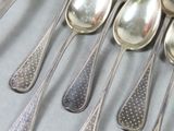 several silver spoons and spoon spoons are lined up on a table
