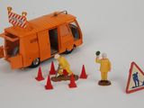 a toy bus with construction workers on it next to traffic cones