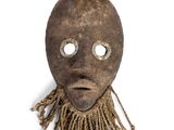 an image of a mask with a face made out of wood