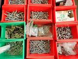 many different types of screws and nuts in the bins