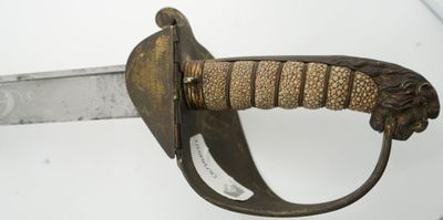 a close up of a sword with a lion head on it