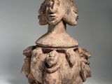 an image of a clay figurine of a woman holding a baby