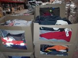 several boxes of clothing are stacked on top of each other in a warehouse