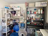 a room with shelves, shelves, and a chair in it