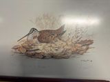 a picture of a painting of a bird on a shelf