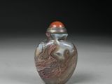 an image of a silver and red glass snuff bottle on a white surface