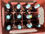 many bottles of wine in a red crate on the floor