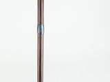 a wooden cane with a metal handle on a white background