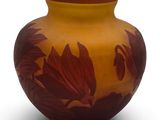 a vase that has a brown and red design on it