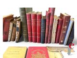 several old books are stacked on top of each other on a table