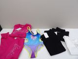 girls swimsuits and t - shirts for sale at a store