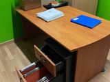 a desk with a file cabinet and a file cabinet in the corner