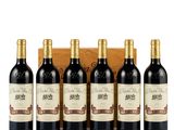 six bottles of red wine in a wooden box