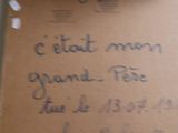 a piece of cardboard with writing on it sitting on a counter