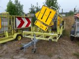 a yellow sign sitting on top of a yellow trailer