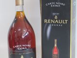 the bottle of wine is next to the box on the table