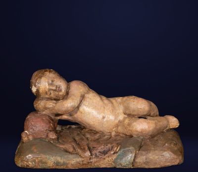 an old statue of a man laying on a rock on a blue background