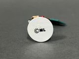 a close up of a small white button with the word ml on it