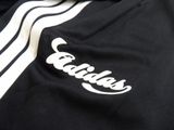 the back of a black jacket with a white and black stripe on it