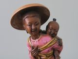 a figurine of a woman holding a baby
